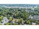 A birds-eye view of residences in a lush, green area, showcasing homes near commercial buildings and cityscapes at 396 Academy St, Alpharetta, GA 30009