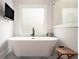 Modern bathroom features a soaking tub in front of the window at 396 Academy St, Alpharetta, GA 30009