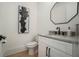 The bathroom features a modern vanity with granite countertops, a black faucet, and a decorative mirror at 396 Academy St, Alpharetta, GA 30009