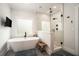 Modern bathroom featuring a soaking tub, glass-enclosed shower, and sleek fixtures at 396 Academy St, Alpharetta, GA 30009