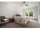 Comfortable bedroom with a ceiling fan and a large window overlooking a green yard at 396 Academy St, Alpharetta, GA 30009