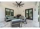 Inviting outdoor covered patio with grill, comfortable seating, and brick accents at 396 Academy St, Alpharetta, GA 30009