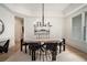 Bright dining room with a large wooden table and custom light fixture at 396 Academy St, Alpharetta, GA 30009