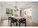 Bright dining room with view of the front yard and modern lighting at 396 Academy St, Alpharetta, GA 30009