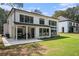 Exterior view of the home showcasing the large yard and outdoor seating area on the patio at 396 Academy St, Alpharetta, GA 30009