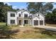 Beautiful new construction with a two car garage, dark trim, black framed windows, and lush landscaping at 396 Academy St, Alpharetta, GA 30009