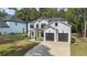 Well-maintained two-story home with attached two car garage and a lush green lawn at 396 Academy St, Alpharetta, GA 30009