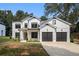 Beautiful two-story home with white siding, black trim, a 2-car garage, and well-manicured lawn at 396 Academy St, Alpharetta, GA 30009