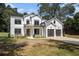 Charming new construction two-story home featuring white siding, black trim and a two-car garage at 396 Academy St, Alpharetta, GA 30009