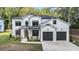 Charming new construction two-story home featuring white siding, black trim and a two-car garage at 396 Academy St, Alpharetta, GA 30009