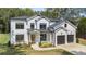 Charming new construction two-story home featuring white siding, black trim and a two-car garage at 396 Academy St, Alpharetta, GA 30009