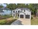 Charming new construction two-story home featuring white siding, black trim and a two-car garage at 396 Academy St, Alpharetta, GA 30009