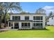 Exterior view of the home showcasing the large yard and outdoor seating area on the patio at 396 Academy St, Alpharetta, GA 30009