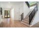 Bright foyer with wooden floors and stairs and a custom door with lots of windows at 396 Academy St, Alpharetta, GA 30009