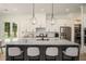 Contemporary kitchen boasting a central island with bar stools, sleek cabinetry, and modern appliances at 396 Academy St, Alpharetta, GA 30009