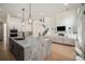 A modern kitchen with granite counters, stainless appliances, large island, and open floor plan create a welcoming space at 396 Academy St, Alpharetta, GA 30009