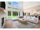 Open living area with soaring windows, a fireplace, and seamless access to the modern kitchen at 396 Academy St, Alpharetta, GA 30009