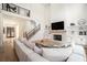 Bright living room with fireplace, built-in shelving, and a view of the front entrance at 396 Academy St, Alpharetta, GA 30009