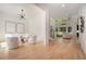 Open-concept living area with lots of natural light, featuring wood floors and a view of the stairs at 396 Academy St, Alpharetta, GA 30009