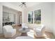 Cozy living room with a unique light fixture, hardwood floors, lots of light and comfy seating at 396 Academy St, Alpharetta, GA 30009