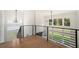 The loft area features hardwood floors and scenic backyard views and is complete with modern light fixtures at 396 Academy St, Alpharetta, GA 30009
