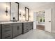 A double sink bathroom with granite countertops and vanity are found in the main bedroom at 396 Academy St, Alpharetta, GA 30009