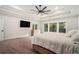 The main bedroom features a tray ceiling, fan, and backyard views with lots of natural light at 396 Academy St, Alpharetta, GA 30009
