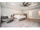 Spacious primary bedroom featuring trey ceilings, a ceiling fan, and sitting area in neutral colors at 396 Academy St, Alpharetta, GA 30009