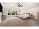 A spacious main bedroom features a tray ceiling, ceiling fan, and natural light creating a relaxing atmosphere at 396 Academy St, Alpharetta, GA 30009