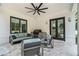 The outdoor patio features an outdoor kitchen, travertine flooring, ceiling fan, and comfortable seating at 396 Academy St, Alpharetta, GA 30009