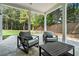 This outdoor patio features travertine floors, comfortable outdoor seating, and backyard views at 396 Academy St, Alpharetta, GA 30009