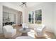Cozy sitting area features wood floors, natural light, stylish decor, and view into dining room at 396 Academy St, Alpharetta, GA 30009