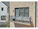 Close up shot of a townhouse balcony with striped outdoor furniture and brick exterior at 6601 Cadence Blvd, Atlanta, GA 30328