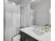 Bright bathroom features a sleek white sink, modern faucet, and shower with a curtain at 6601 Cadence Blvd, Atlanta, GA 30328