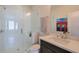 Bright bathroom featuring a glass shower, modern vanity, and decorative art at 6601 Cadence Blvd, Atlanta, GA 30328