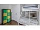 Bunk beds with a colorful storage unit in a simple and functional bedroom at 6601 Cadence Blvd, Atlanta, GA 30328