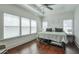 Bright bedroom with hardwood floors, a ceiling fan, and three large windows at 6601 Cadence Blvd, Atlanta, GA 30328