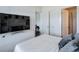 Clean bedroom with a large TV, white bedding, and plenty of closet space at 6601 Cadence Blvd, Atlanta, GA 30328