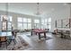 Clubhouse interior with a pool table and large windows that flood the space with natural light at 6601 Cadence Blvd, Atlanta, GA 30328