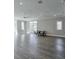 Spacious common area with hardwood floors, recessed lighting, and large windows, ideal for gatherings and activities at 6601 Cadence Blvd, Atlanta, GA 30328