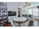 Stylish dining area with a wet bar, media area, and chic lighting fixtures at 6601 Cadence Blvd, Atlanta, GA 30328