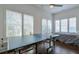 Game room featuring two ping pong tables, multiple windows and a bed in view at 6601 Cadence Blvd, Atlanta, GA 30328