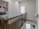 Hallway with hardwood floors and wrought iron railings, leading to a bedroom at 6601 Cadence Blvd, Atlanta, GA 30328
