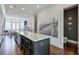 Open kitchen with a large center island, stainless steel appliances, and modern finishes at 6601 Cadence Blvd, Atlanta, GA 30328