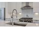 Close-up of the kitchen featuring stainless steel appliances, a modern sink, and white countertops at 6601 Cadence Blvd, Atlanta, GA 30328