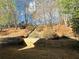 Landscaped backyard with retaining wall leading up to a wooded area at 272 Lynshire Sw Ct, Marietta, GA 30064