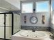 Inviting bathroom featuring a jacuzzi tub, separate glass shower and mosaic tile accents at 272 Lynshire Sw Ct, Marietta, GA 30064