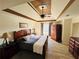 Main bedroom with tray ceilings, carpet and wooden furniture at 272 Lynshire Sw Ct, Marietta, GA 30064