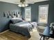 Stylish bedroom with gray walls, laminate flooring, cozy bed, and lots of natural light from two windows at 272 Lynshire Sw Ct, Marietta, GA 30064