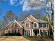 Charming two-story brick home featuring a manicured lawn and complemented by mature trees at 272 Lynshire Sw Ct, Marietta, GA 30064